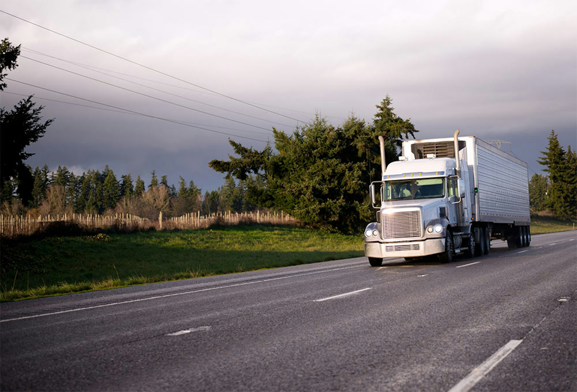 Truck driving with storm behind